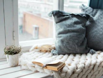 Blanket and pillow next to window