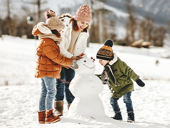 Family building a snowman