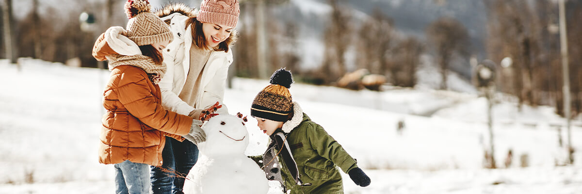 Family building a snowman